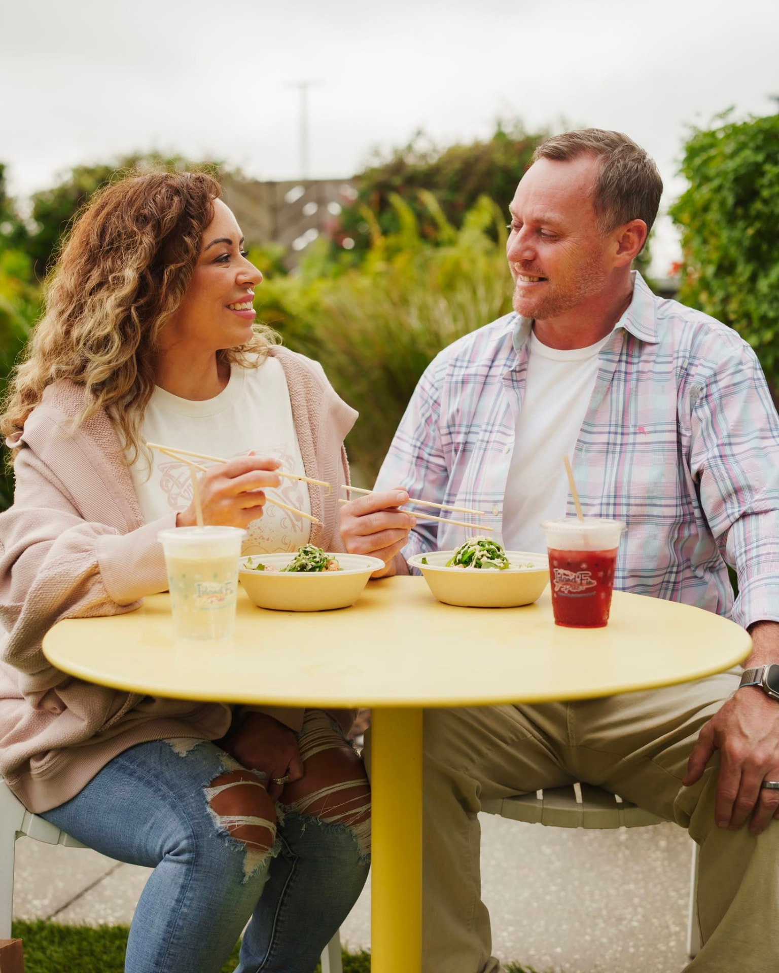 Guests enjoying poké bowls outdoors at Island Fin Poké Co. Beachwalk
